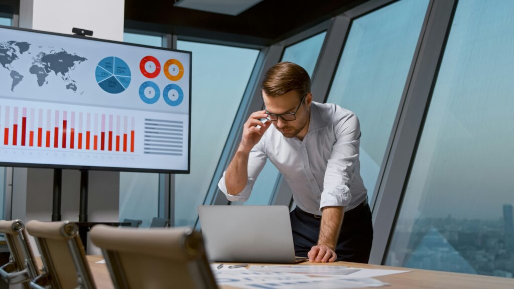 Young corporate manager working on laptop